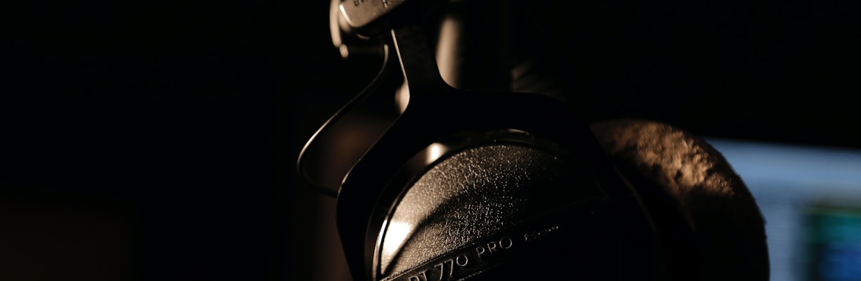 black and gray headphones on black background